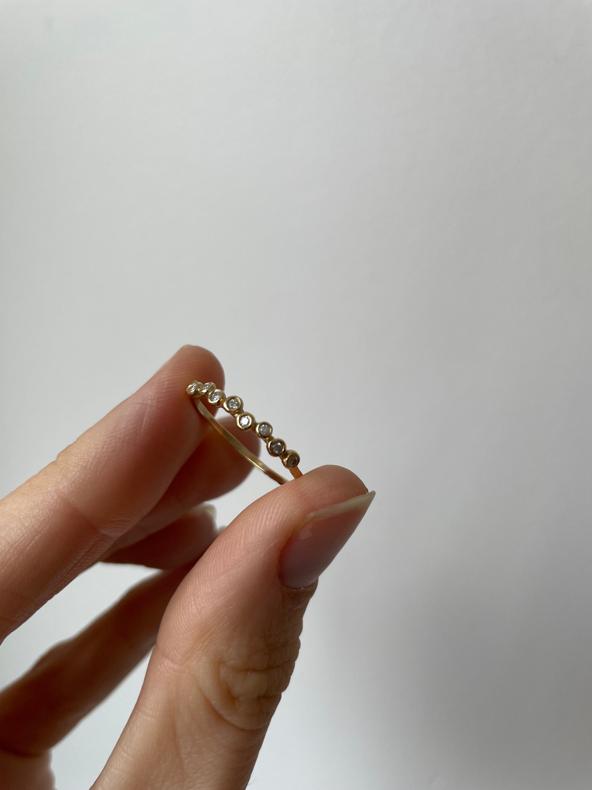 a 9 diamond ring with hammered yellow gold, 9 white diamonds size 8