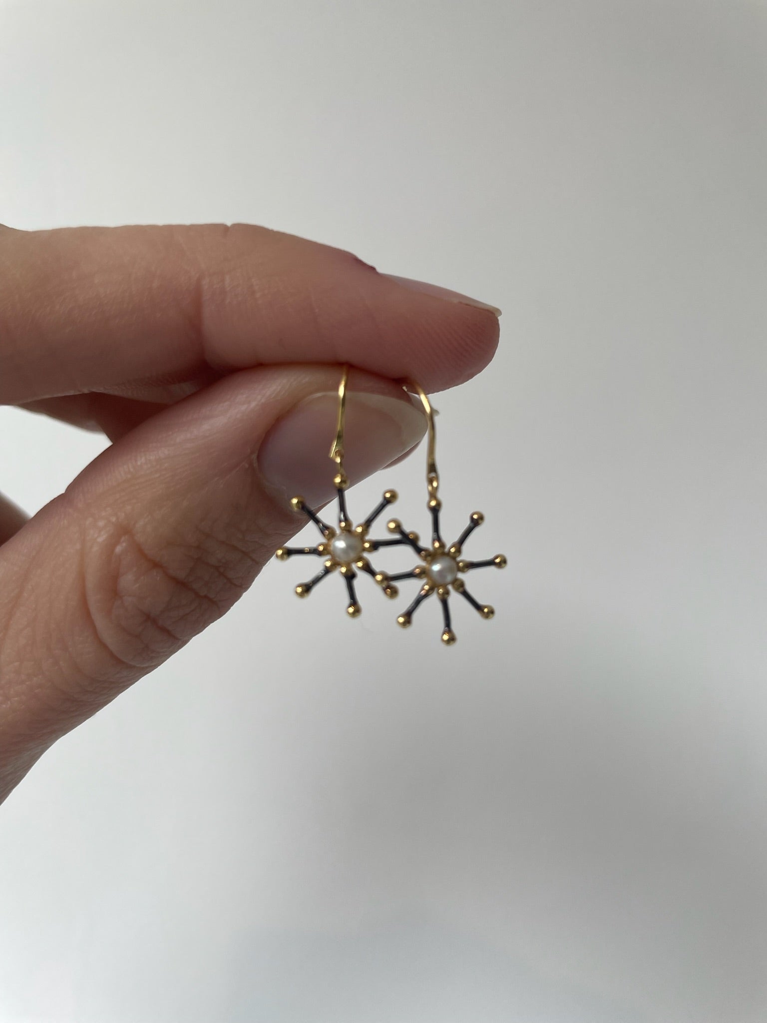 Gold and pearl starburst earrings 