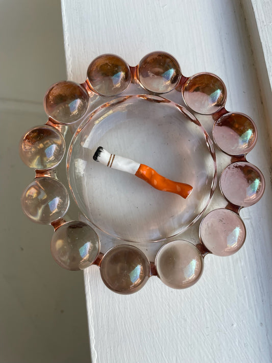 a cig #12 artwork made of clay, ashes, gold leaf, and gloss coating