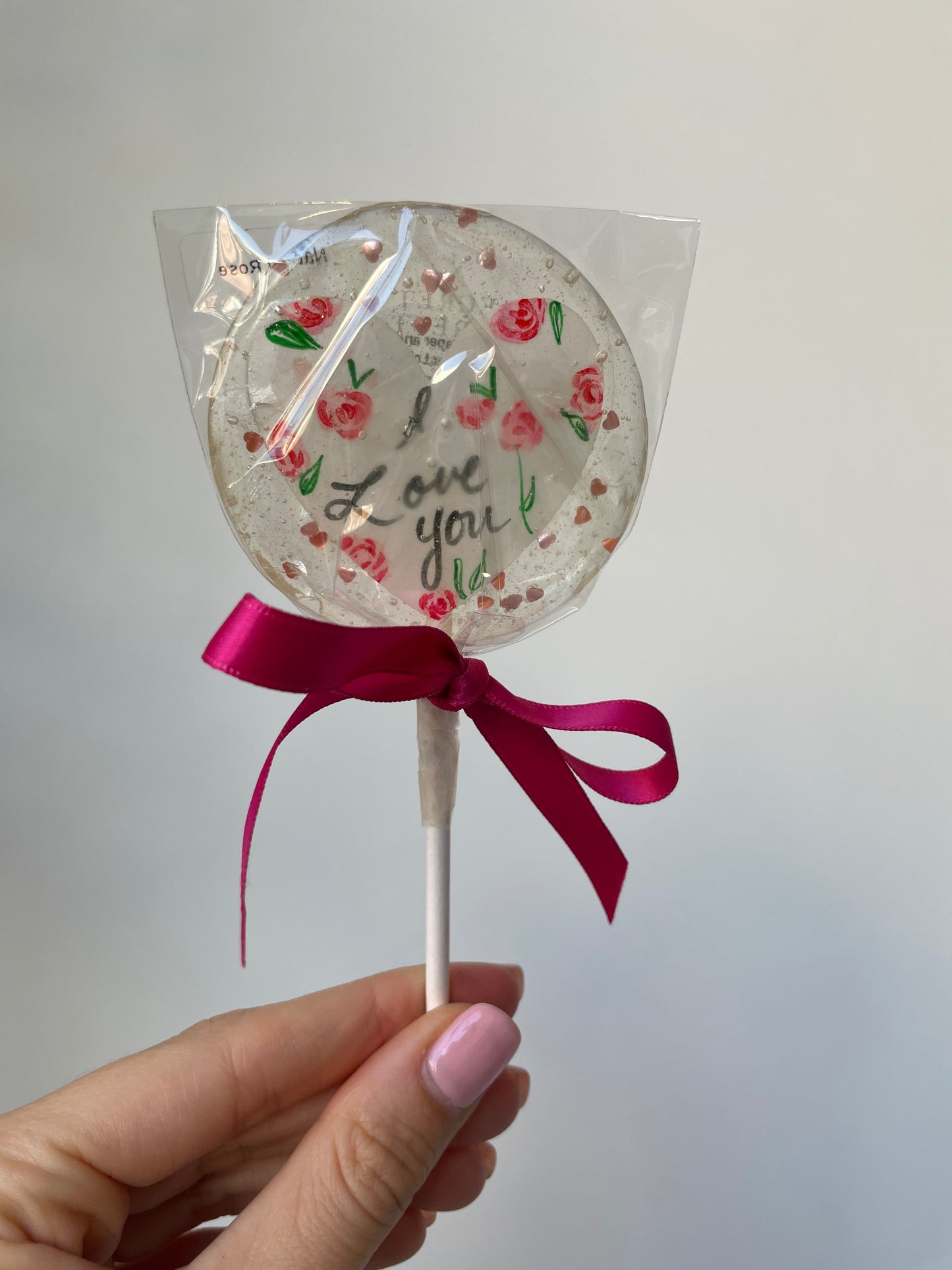 an i love you lollipop candy in natural rose flavored