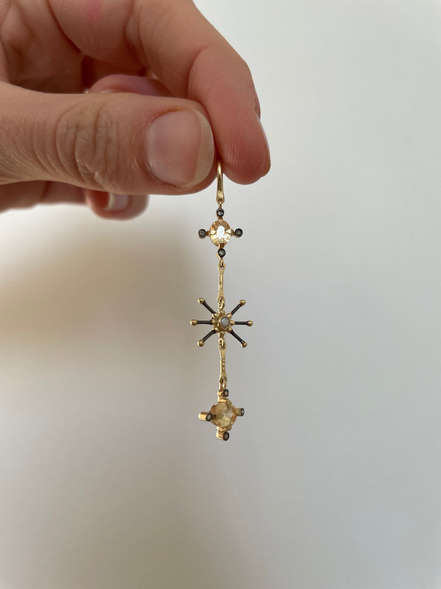 single dangly gold earring with yellow sapphire, diamonds and a freshwater pearl