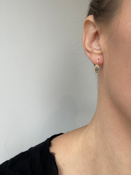 dainty gold dangly earrings with a small turquoise, diamond and oxidized silver