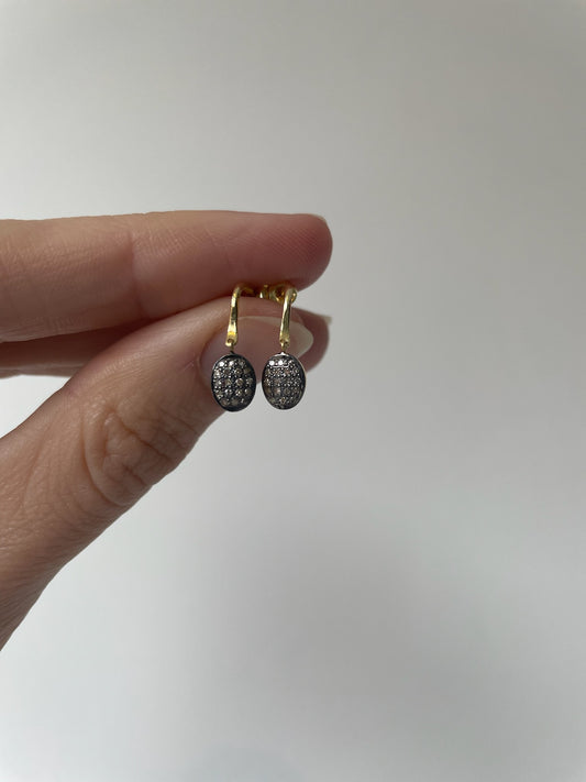 Small dangly gold oval earrings with small diamonds