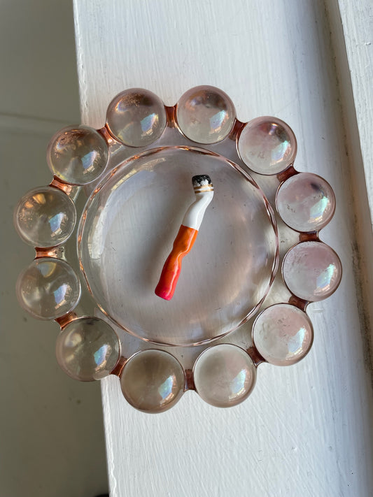 a cig #17 artwork made of clay, ashes, gold leaf, and gloss coating