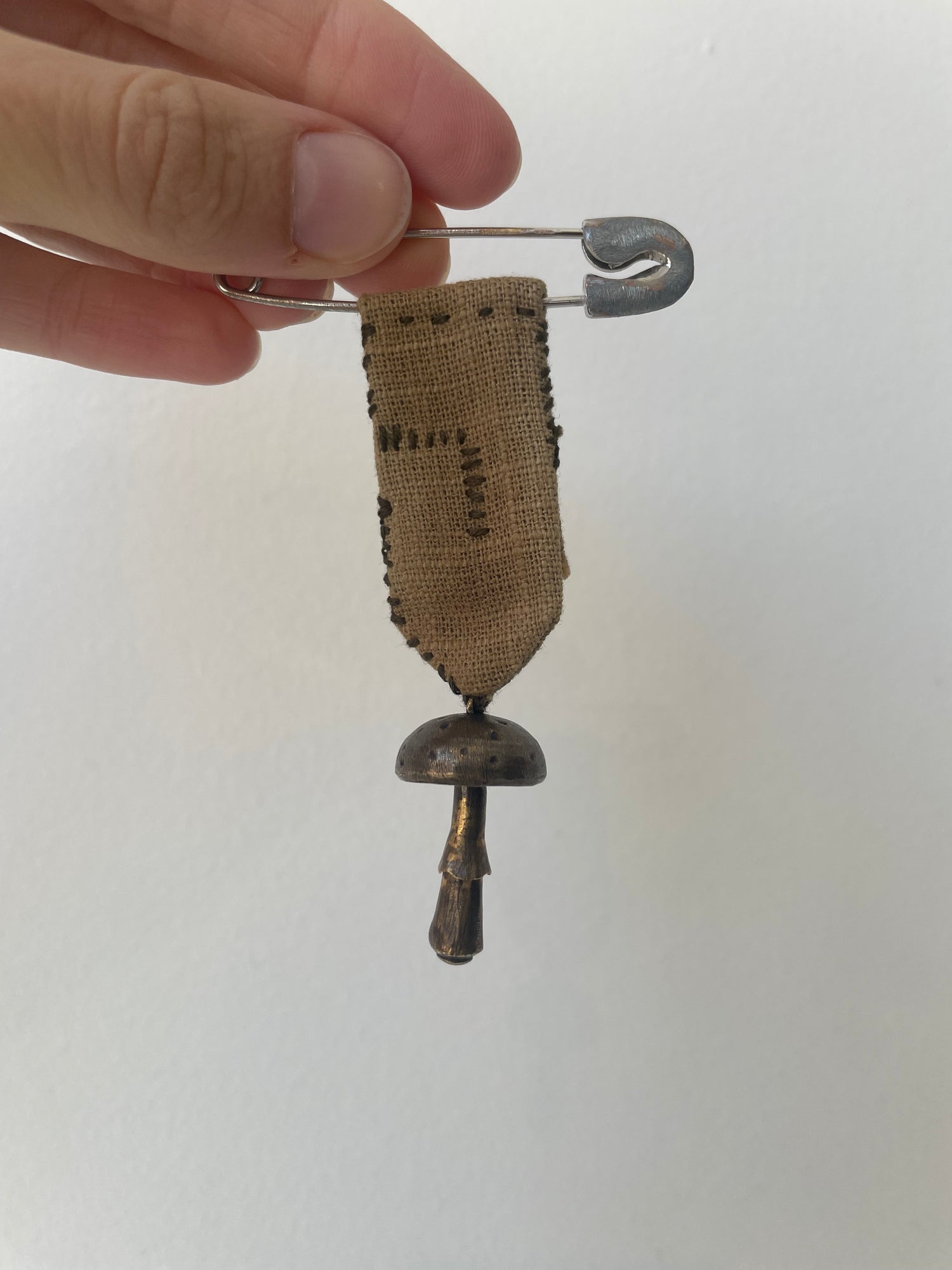 an aleksandr manamïs mushroom pin with brass