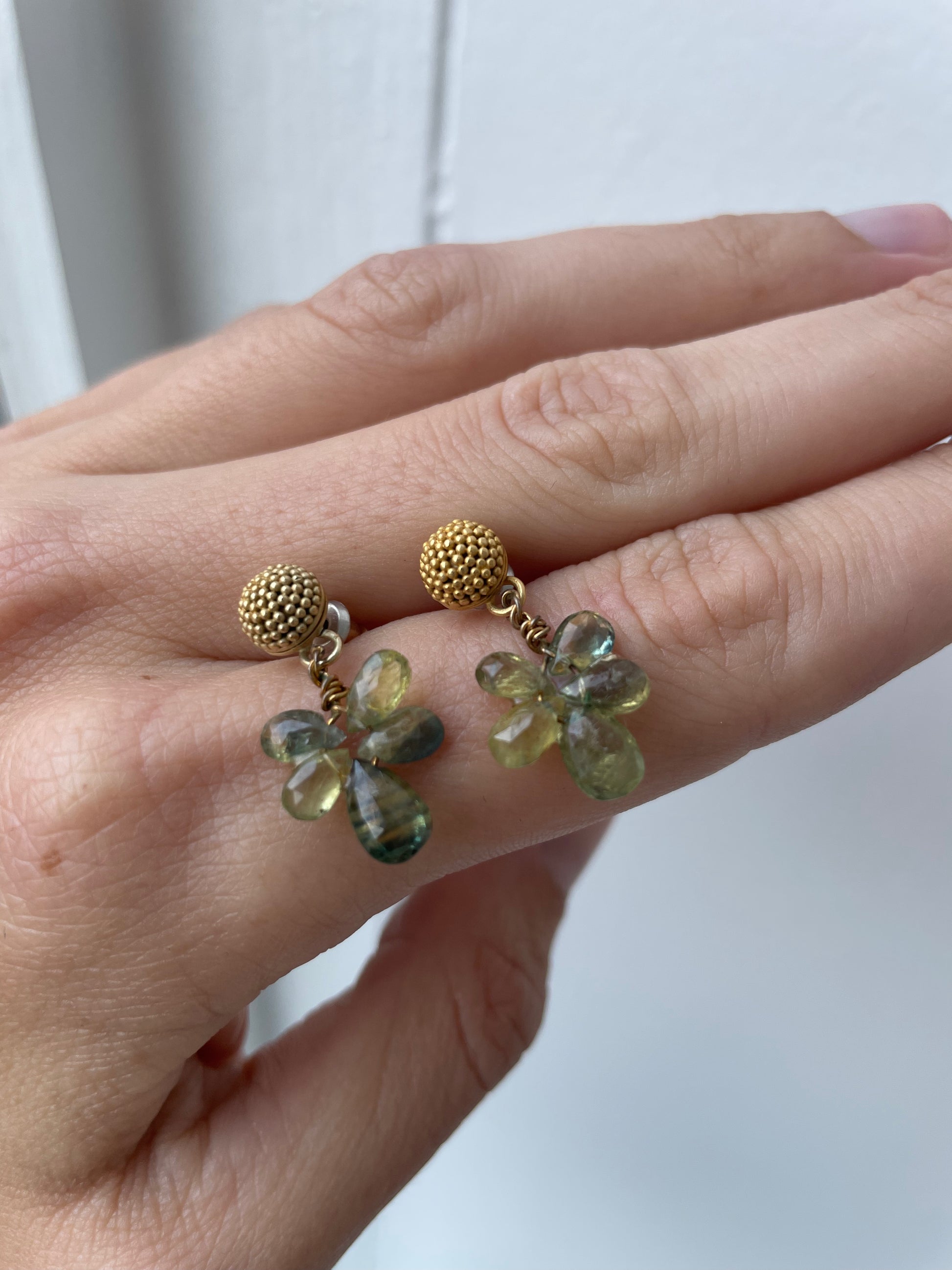 a tourmaline stud earrings with solid gold and green tourmaline