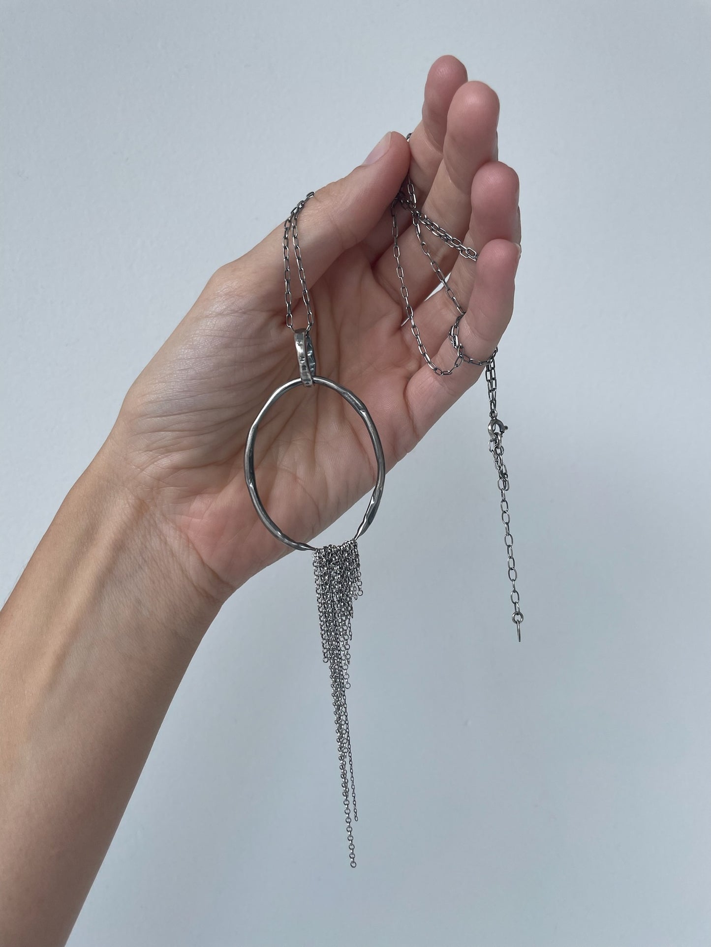 a long silver pendant necklace in sterling silver