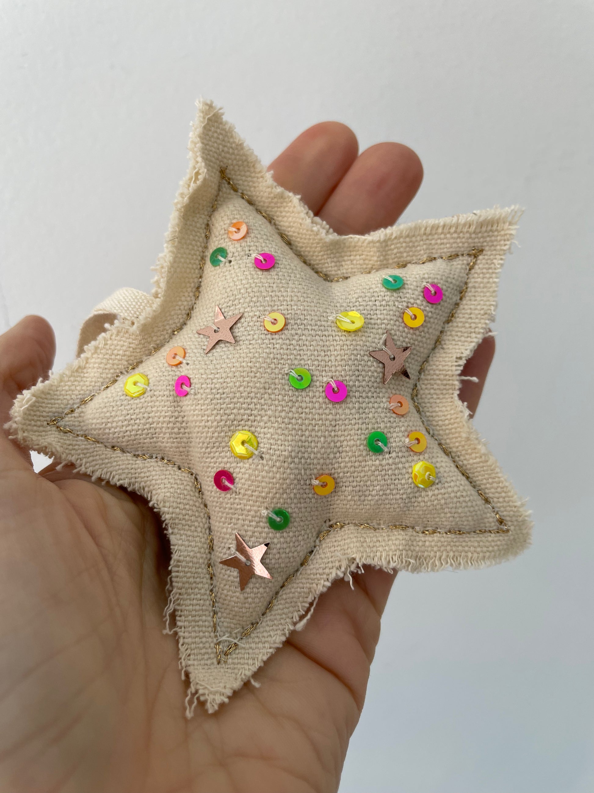 a confetti star lavender ornament with lovingly made by hand